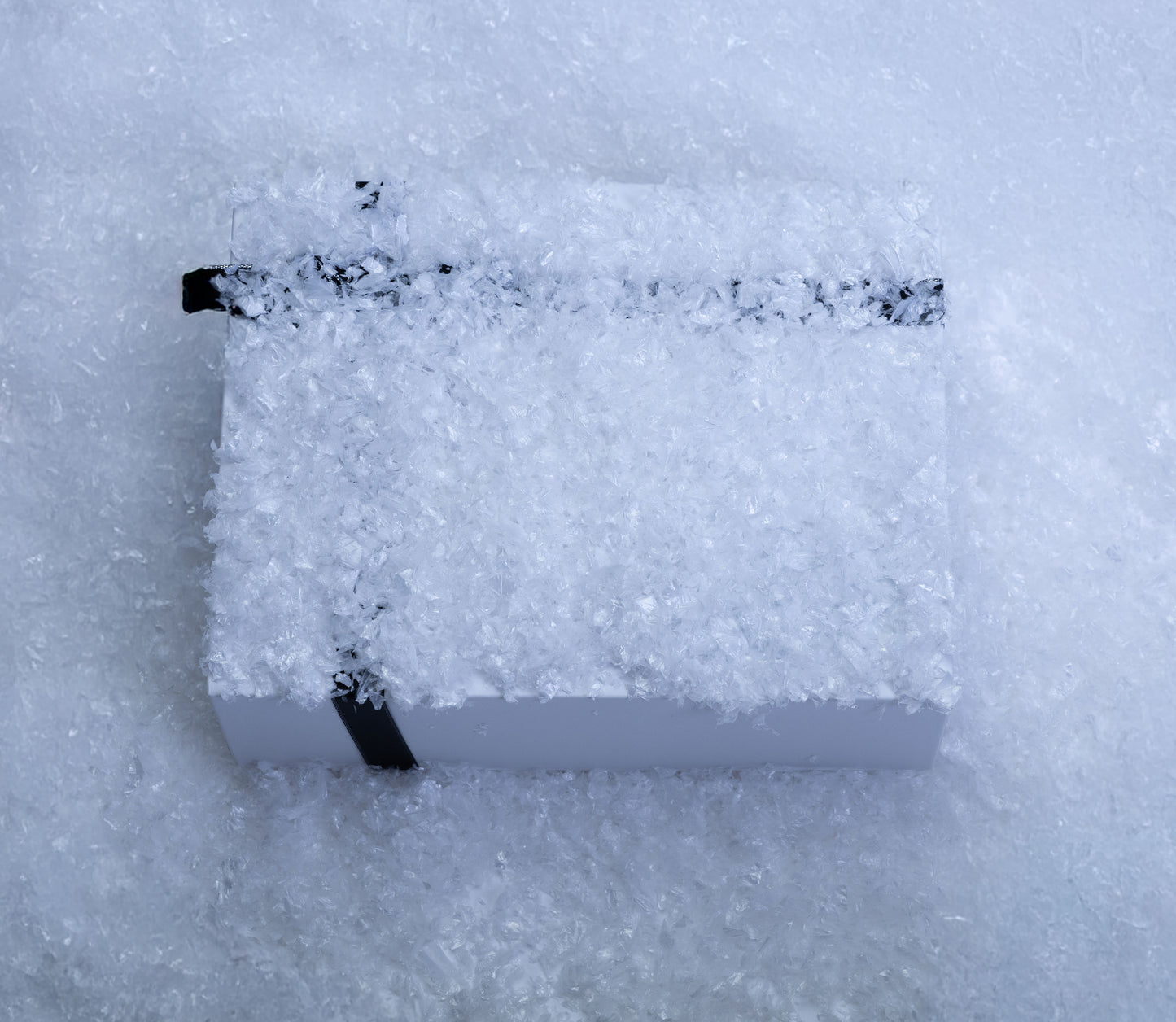 Holiday season oud and bergamot candle and reed diffuser gift set in a snow-filled presentation box