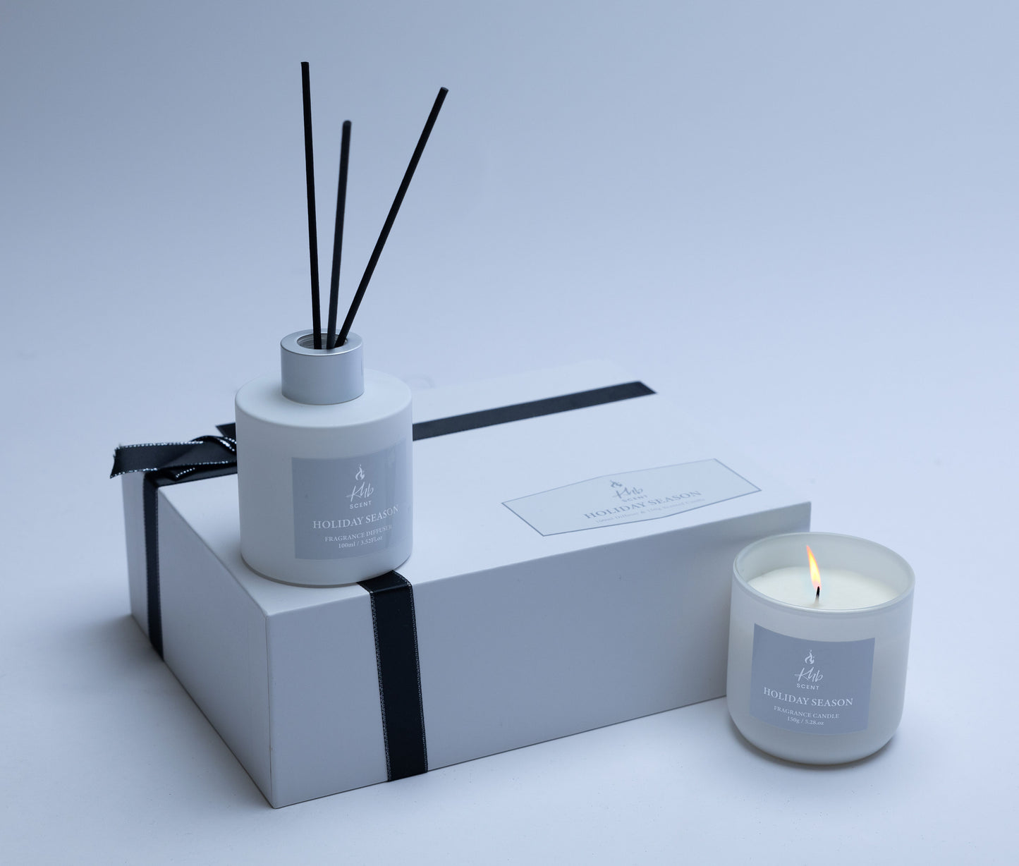 KHB SCENT holiday season oud and bergamot candle and Reed diffuser gift set elegantly packaged with a black ribbon