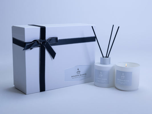 Holiday season oud and bergamot candle and reed diffuser gift set in elegant white packaging